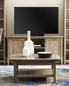 Origins by Stickley TV console with TV on top and coffee table with decorative white vases