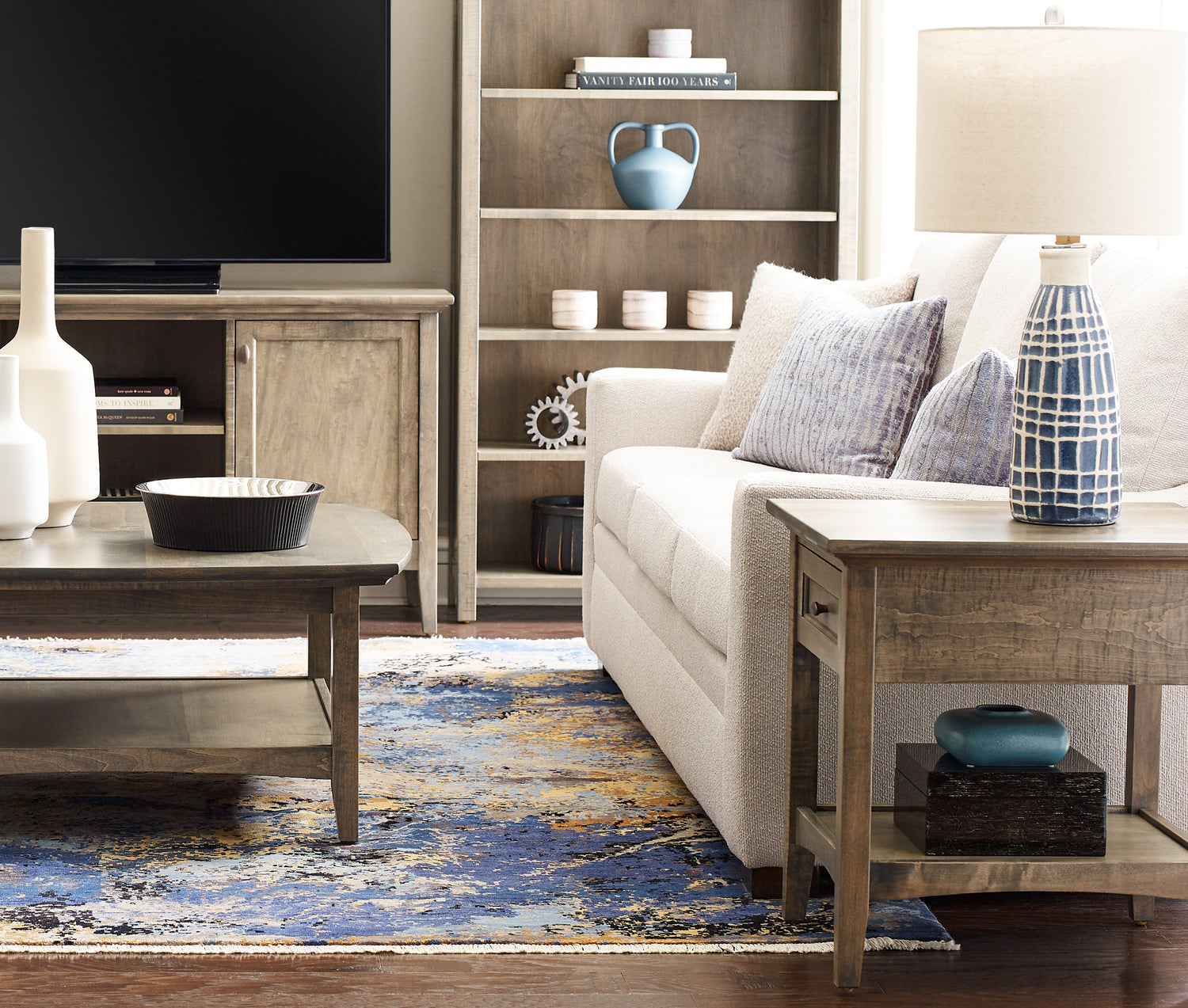 Origins by Stickley Revere living room set up with end table, coffee table, book case, and TV console table.