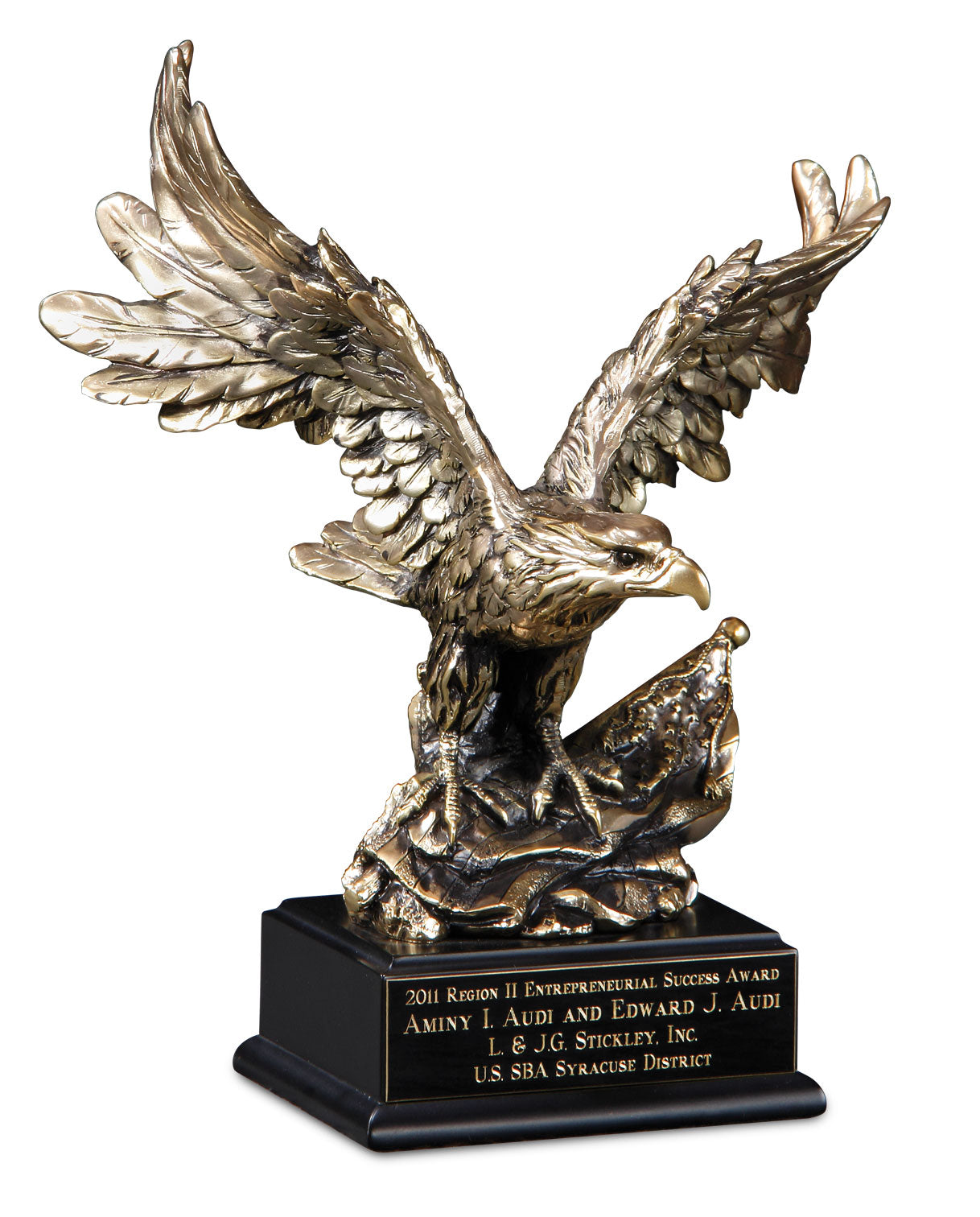 Bronze eagle sculpture award with wings spread, mounted on a black base. The plaque reads: “2011 Region II Entrepreneurial Success Award – Aminy I. Audi and Edward J. Audi – L. & J.G. Stickley, Inc. – U.S. SBA Syracuse District.”