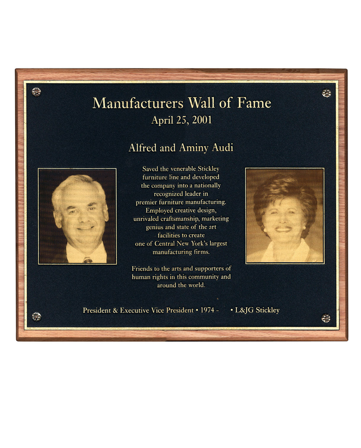 Plaque titled "Manufacturers Wall of Fame" dated April 25, 2001, honoring Alfred and Aminy Audi for revitalizing the Stickley furniture brand and transforming it into a nationally recognized leader. Includes sepia-toned portraits of Alfred and Aminy Audi and a dedication noting their contributions to craftsmanship, design, and the Central New York community.