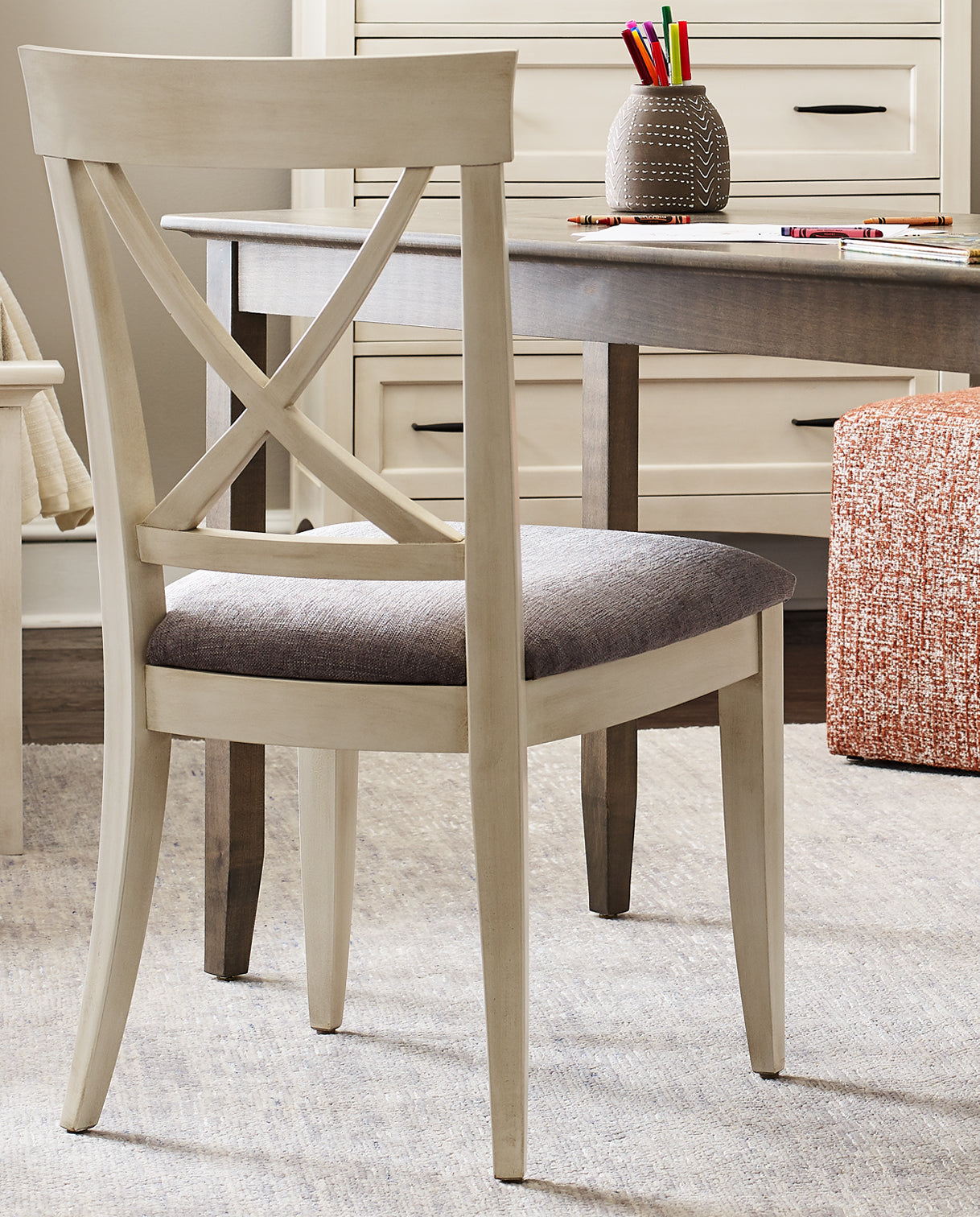 Close up of a Revere Upholstered Side Chair in front of a desk