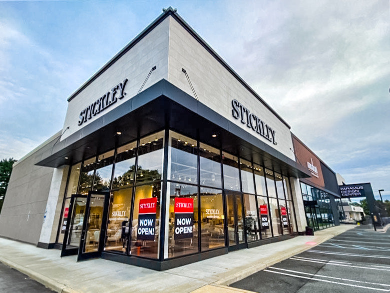 Exterior view of the Stickley Paramus Design Center, featuring a modern glass storefront with bold signage and “Now Open” displays—highlighting a premier destination for luxury furniture and interior design in northern New Jersey.